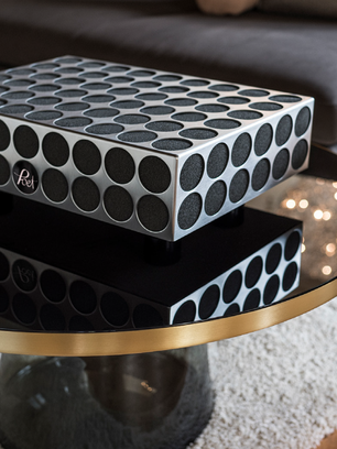 Modern audio equipment with circular pattern on glass table