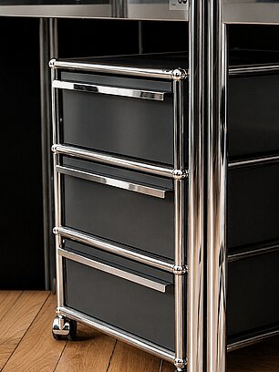 Modern office drawer unit with black panels and chrome frame