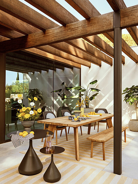 Modern patio with wooden pergola, dining table, chairs, and potted plants