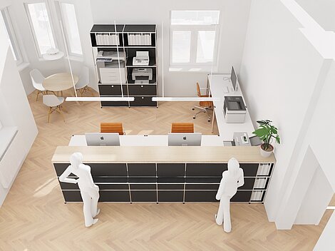 Modern office layout with wooden flooring, desk with computers, and seating area