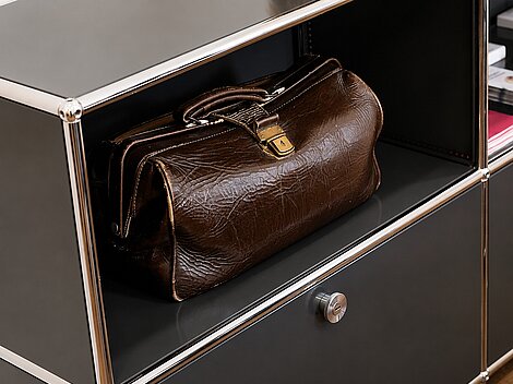 Brown leather briefcase stored on a shelf in an office setting